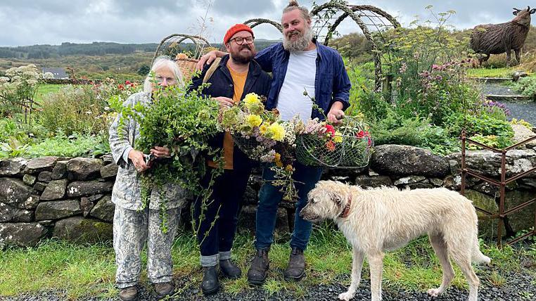 Banjo Beale with neighbour Chris, husband Ro and Grampa the dog gathering flowers