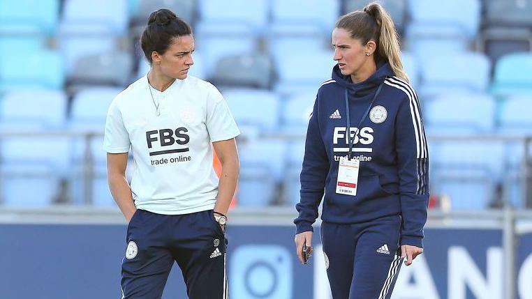 Jess Sigsworth and Abbie McManus on the pitch before Leicester City's Vitality Women's FA Cup quarter-final match v Manchester City.
