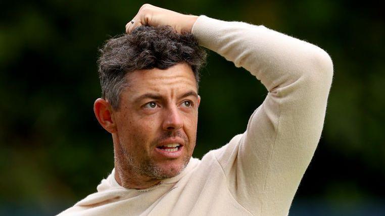 Rory McIlroy in a cream jumper