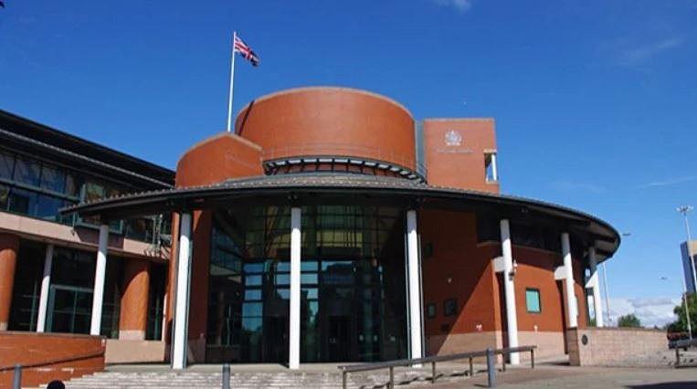 General view of the red-bricked and modern Preston Crown Court, on a sunny day with a blue sky
