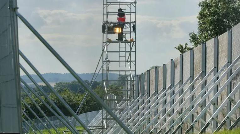Part of a large fence that surrounds the Glastonbury Festival site.