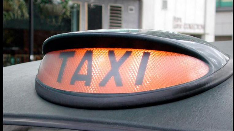 A taxi light on top of a vehicle