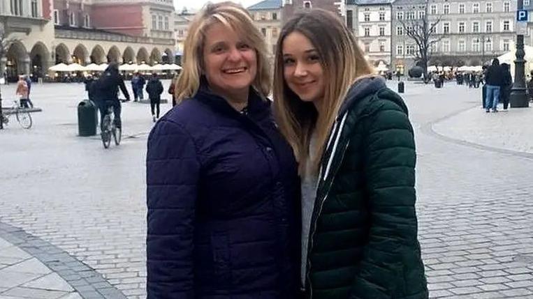 Carole Gould, left, stands next to her daughter Ellie Gould in a square in Europe.