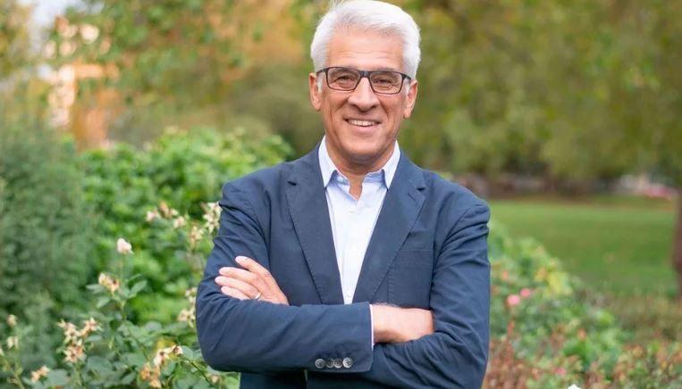 Steve Chalke wearing a suit and shirt standing in a garden