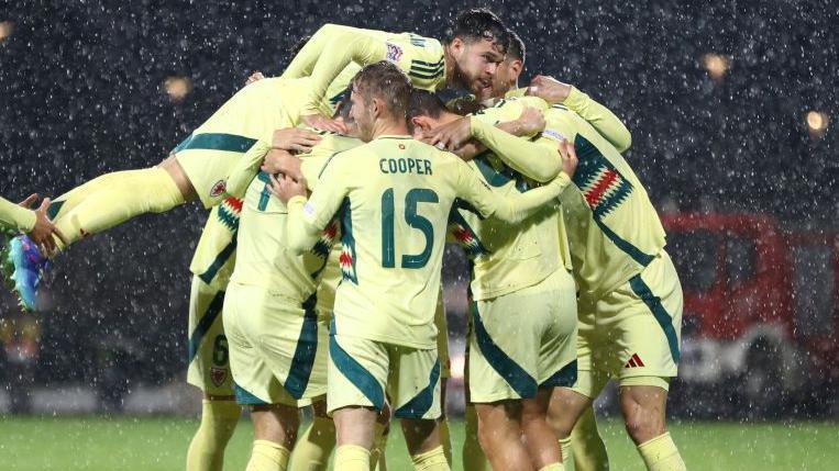 Wales players celebrate Kieffer Moore's goal in Montenegro