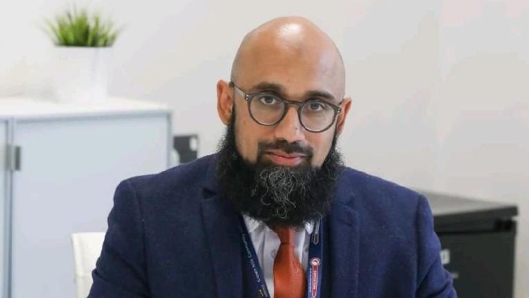 A man with a beard in a suit and tie