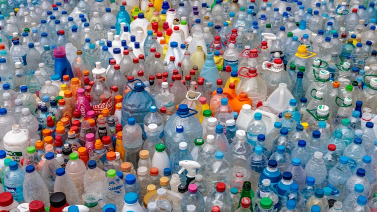 Hundreds of different types of plastic bottle lined up as part of a display