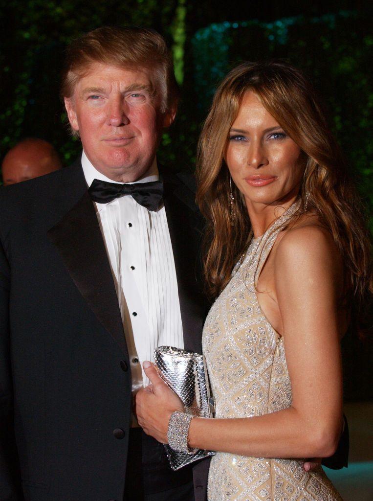 Donald and Melania Trump photographed at the 2005 Vanity Fair Oscar Party in Los Angeles, California. She is wearing a sparkly dress and he is in a tuxedo.