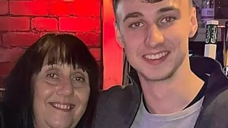 Jay Slater poses with his arm around his mother Debbie Duncan's shoulder. Both are smiling for the camera.