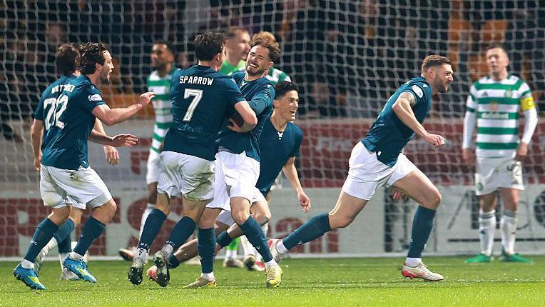 Liam Gordon sweeps in Motherwell's equaliser and wheels away in celebration
