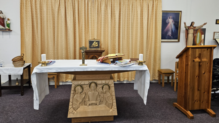 An altar in a church is pictured with white cloth