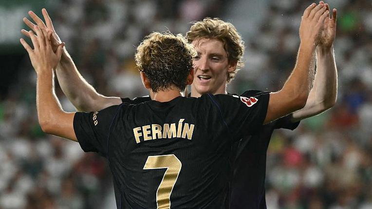 Barcelona's Spanish midfielder #07 Fermin Lopez celebrates with Barcelona's British forward #17 Anthony Gordon scoring his team's fourth goal