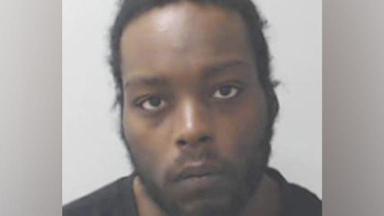 Jahvid Frith, man looking at camera in police mugshot, with dark stubble