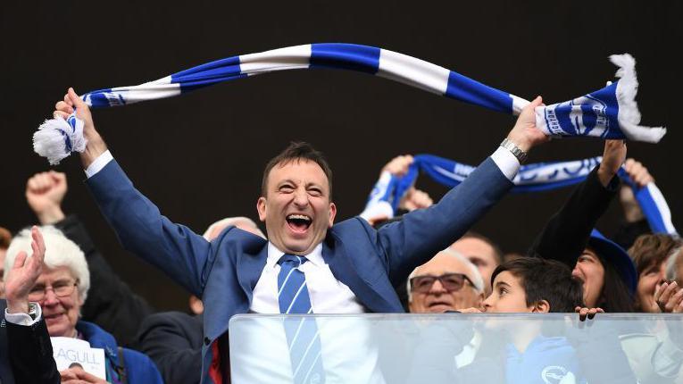 Celebrations take place at the end of the Sky Bet Championship match between Brighton & Hove Albion and Wigan Athletic at Amex Stadium on April 17, 2017 in Brighton.  Chairman Tony Bloom is holding a scarf and waving it above his head.