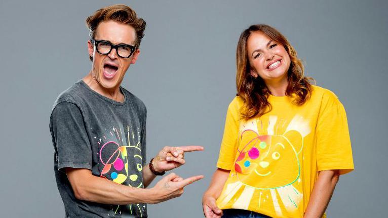 Tom and Giovanna Fletcher in Children in Need t-shirts.