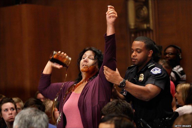 Commercial fisherwoman Diane Wilson of Seadrift, Texas, pours a jar of syrup made to look like oil over herself at a Senate Energy and Natural Resources Committee hearing about the BP Deepwater Horizon oil spill