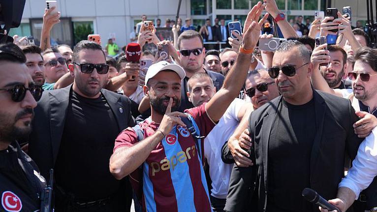 Mohamed Salah with his finger to his lips as he engages with the Trabzonspor fans