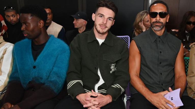 Manchester City and England international Marc Guéhi, Arsenal and England midfielder Declan Rice, Former Manchester United and England defender Rio Ferdinand attend the Burberry Summer 2025 show during London Fashion Week