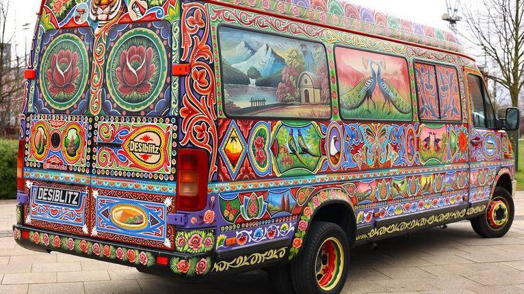 A van covered in colourful artwork