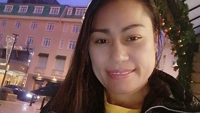 Rebecca Frasco is pictured in front of the Pomme D'Or hotel in St Helier. She is wearing a black jacket and yellow top. 