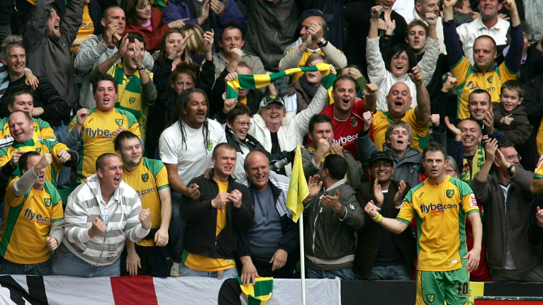Norwich City striker Jamie Cureton celebrates scoring their second goal with fans during the Championship match against Ipswich Town at Carrow Road in 2007