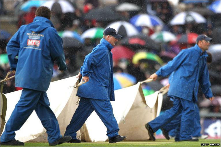 Groundsmen bring on the covers yet again on the third day of play at the Rose Bowl