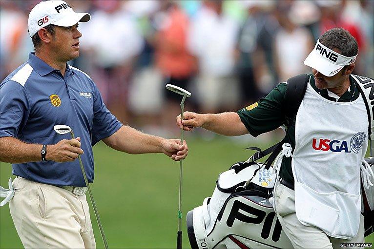 Lee Westwood takes hold of his putter on the first