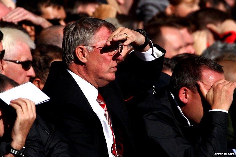 Sir Alex Ferguson shields his eyes from the sun