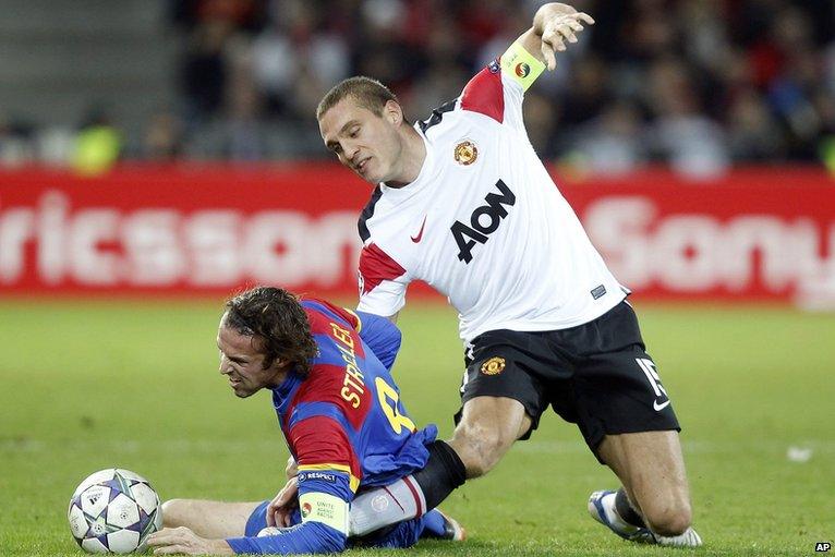 Nemanja Vidic is injured in a tackle with goalscorer Marco Streller