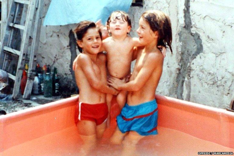 Messi (middle) plays with his brothers at his home in Buenos Aires