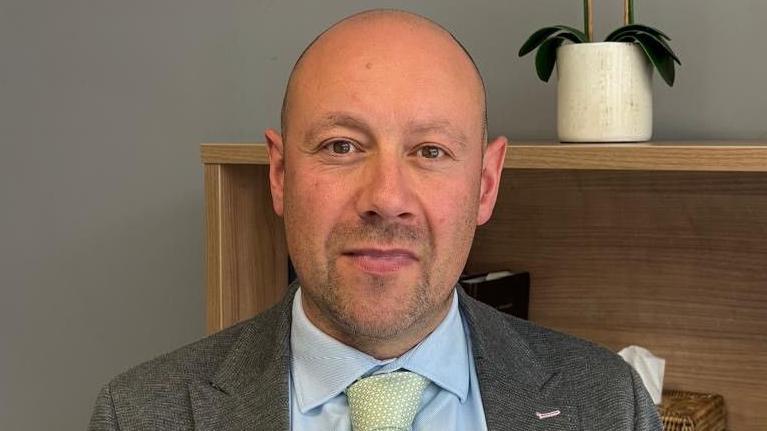Paul Kissen of Thompsons Solicitors, man in shirt, tie and jacket, looking at camera.