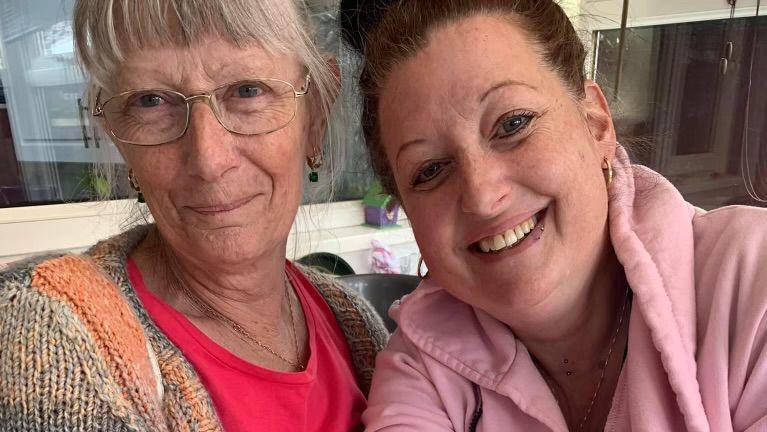 Sharon Taffs and her daughter Louise Miller showing off matching tattoos