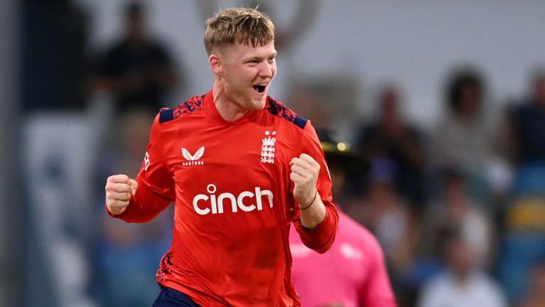 Dan Mousley punches the air in celebration after taking a wicket for England in a white-ball international