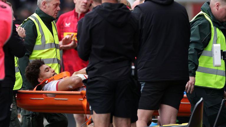 Andy Onyeama-Christie is stretchered off after suffering what looked a serious injury on seven minutes