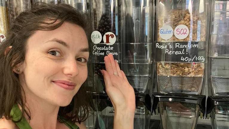 Rosie from Roots posing with a dispenser of "Rosie's Random Cereal"