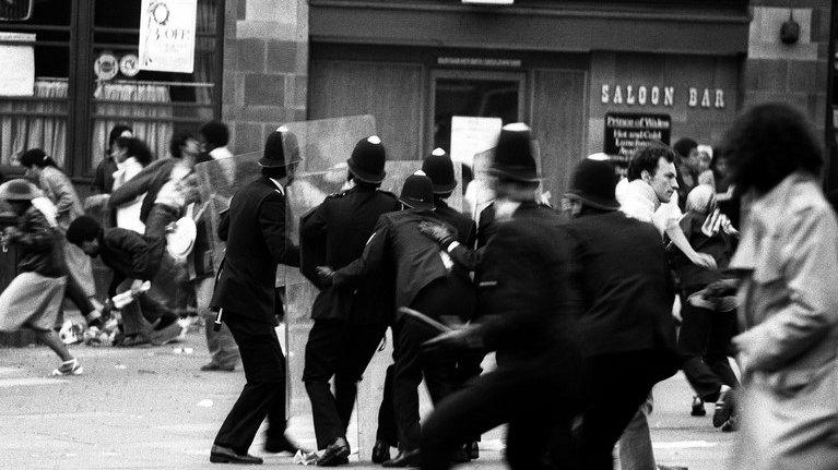 Police with riot shields in Brixton in 1981