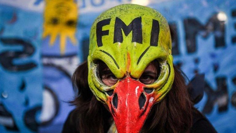 A woman demonstrates while legislators debate a bill to put a stop on public services taxes raising in Buenos Aires, on May 09, 2018.