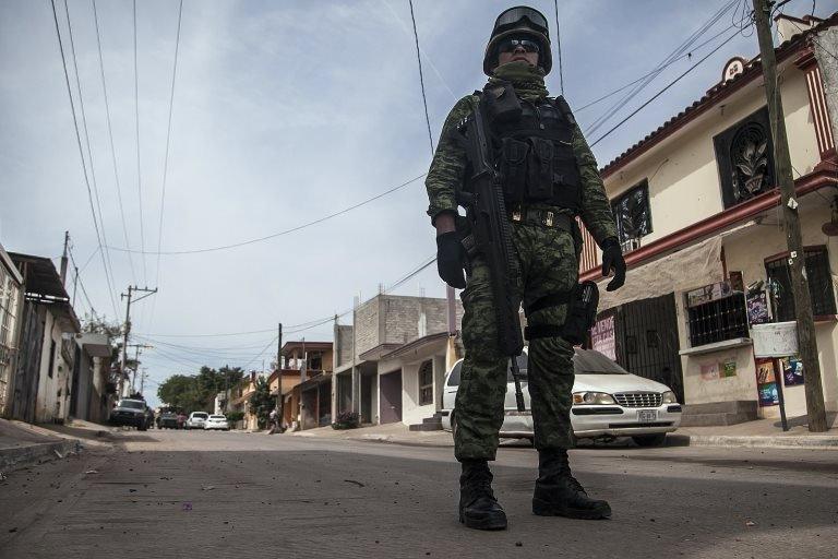 Mexican soldiers patrol during an operation against alleged members of organized crime in Culiacan, Sinoaloa state, Mexico on February 16, 2018