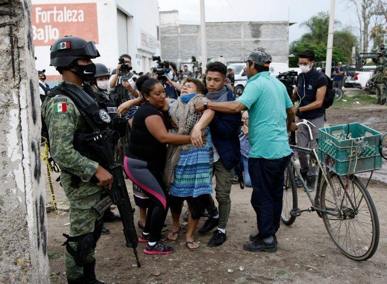 A woman reacts near the crime scene where 24 people were killed in Irapuato, Guanajuato state, Mexico, on July 1, 2020.