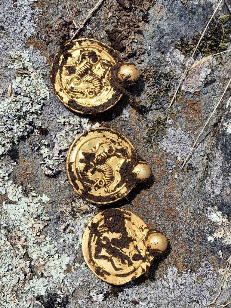 Three coin-like gold pendants