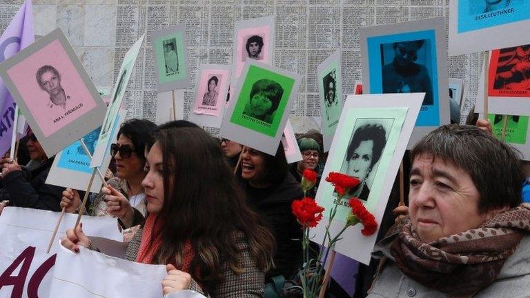 Demonstrators with posters of people who went missing during former General Augusto Pinochet"s regime, are seen during a rally marking the anniversary of the 1973 military coup in Santiago, Chile September 10, 2017