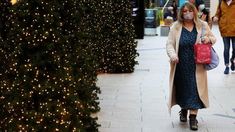 A woman shops in Belfast during the pandemic