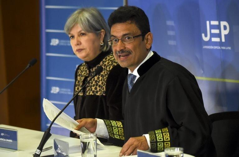 Colombian magistrate of the Peace Court Jesus Bobadilla (R) speaks next to Colombian President of the Special Jurisdiction for Peace Patricia Linares (JEP)