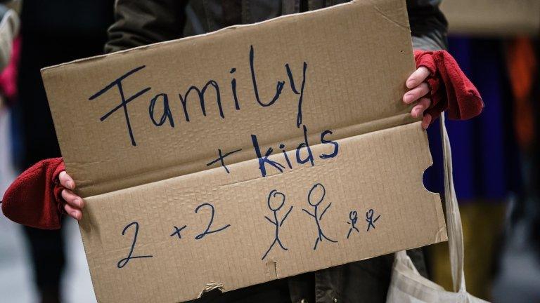 A sign on cardboard that says family + kids