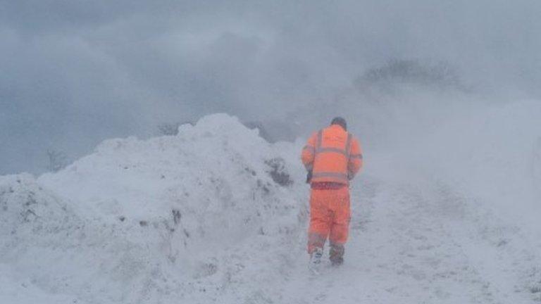 Man in florescent clothing in snow