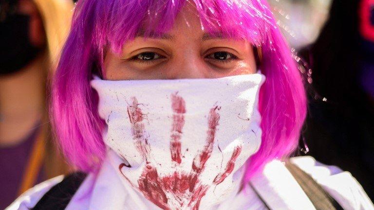 A woman takes part in a march along the streets as part of the International Women"s Day in San Salvador, El Salvador, March 6, 2022.