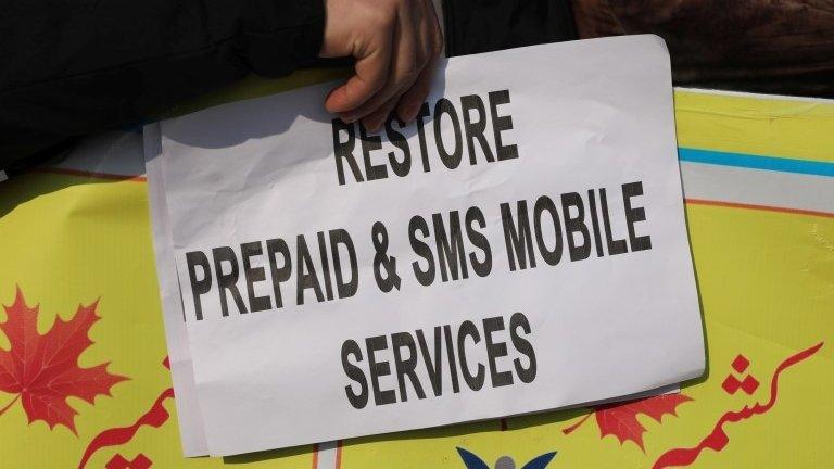 A Kashmiri youth holds a placard during a protest against an Internet, SMS and prepaid mobile services blockade, in Srinagar, Kashmir, India, 19 December 2019.