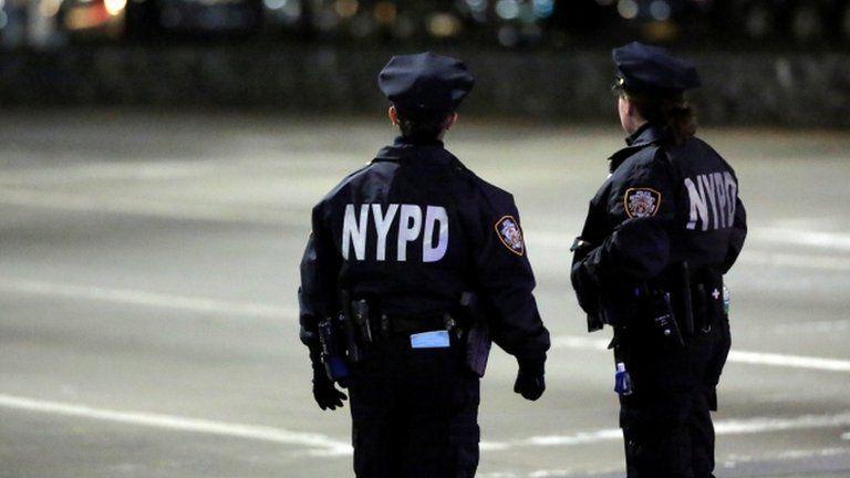 Two NYPD police officers standing on street