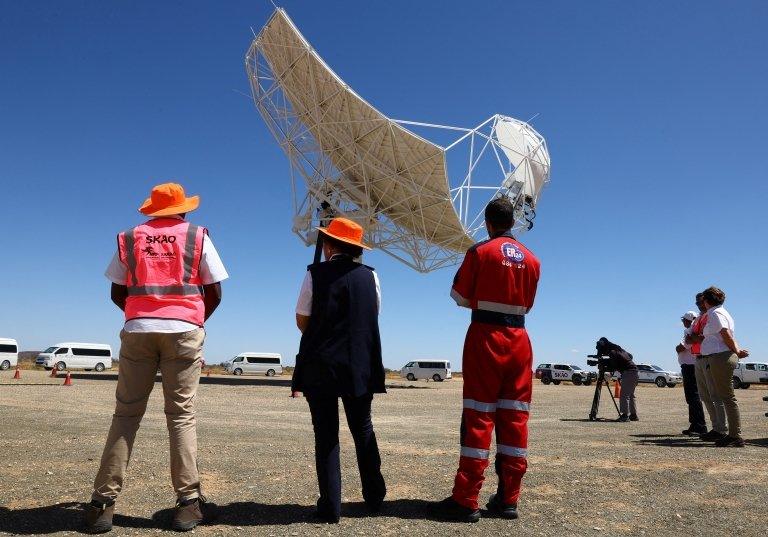 scientists looking at telescopes