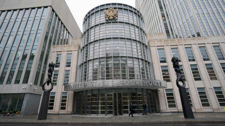 People walk past the Federal Courthouse in Brooklyn where the FFA trial is talking place on November 13, 2017 in New York